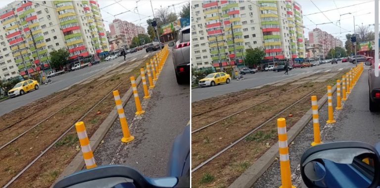 Stradă cu linii de tramvai și stâlpi de protecție galbeni pentru separarea traficului