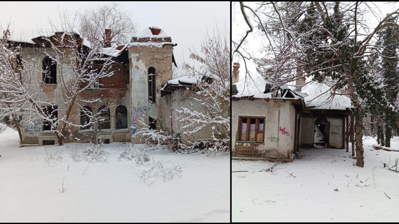 Clădire istorică abandonată în ruine, acoperită de zăpadă, cu graffiti pe pereții degradați și ferestre sparte, într-un peisaj de iarnă.