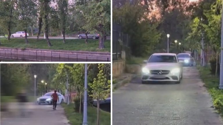 Mașini circulând pe alee pietonală lângă Lacul Colentina, în zonă verde urbană la apus