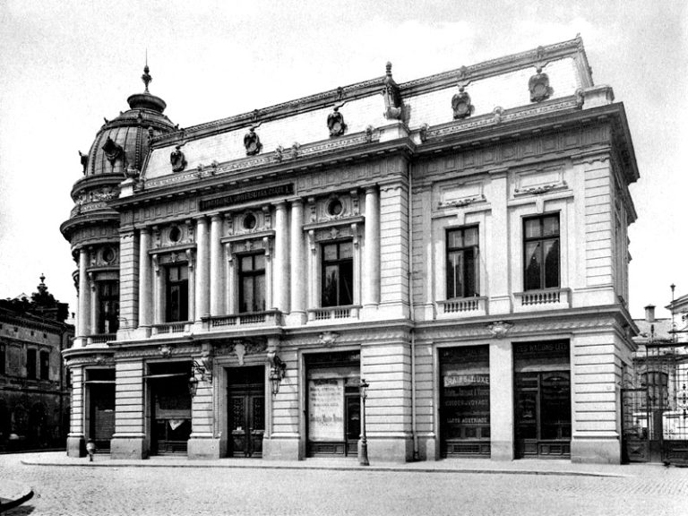 Clădire istorică în stil neoclasic, posibil teatru sau instituție culturală, cu coloane impunătoare și detalii arhitecturale ornamentale