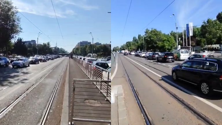 Trafic intens și linii de tramvai pe Șoseaua Olteniței din București, într-o zi însorită, cu numeroase autoturisme și infrastructură urbană modernă.